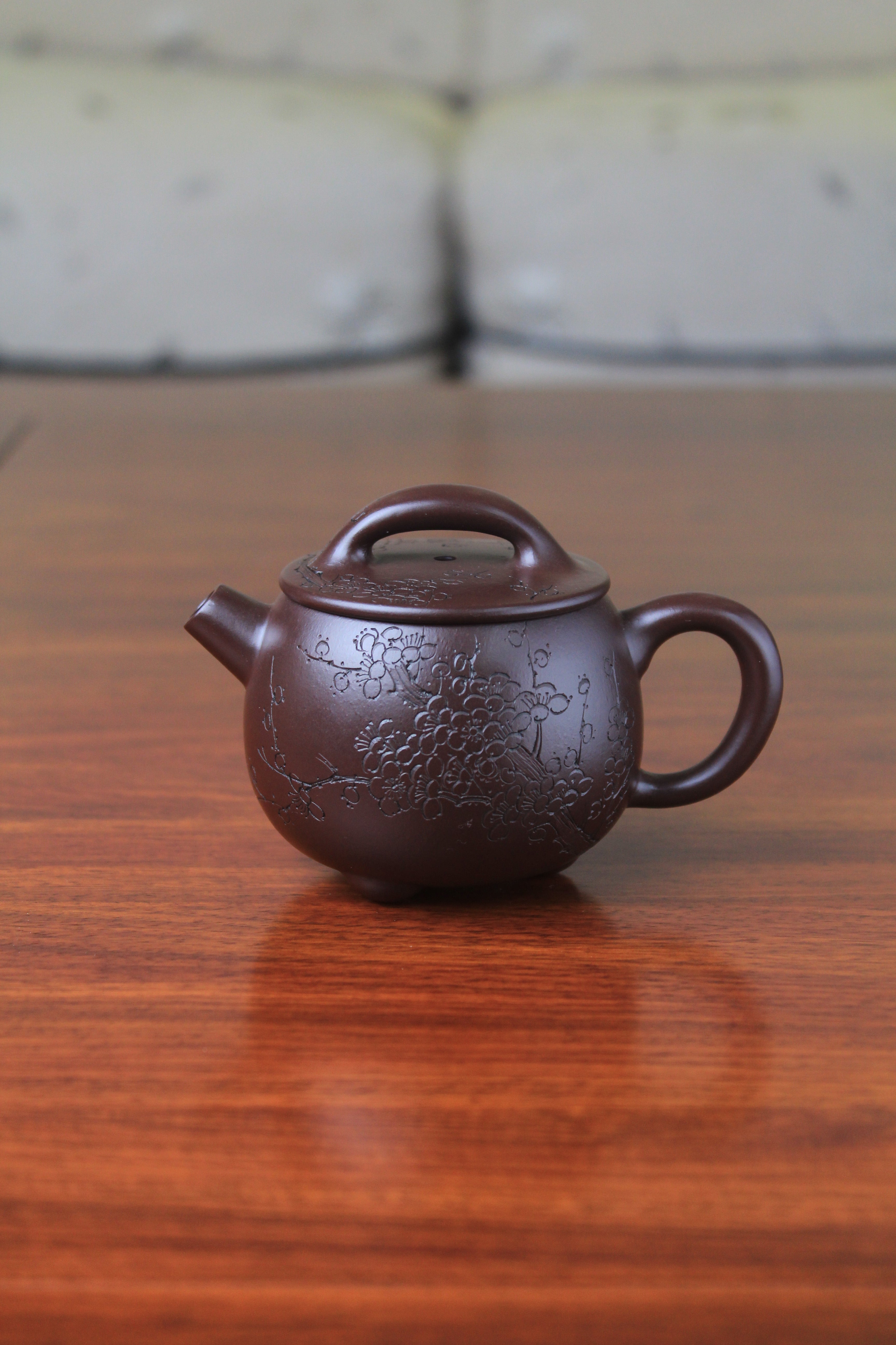 Cute chinese teapot handmade with purple clay on the table